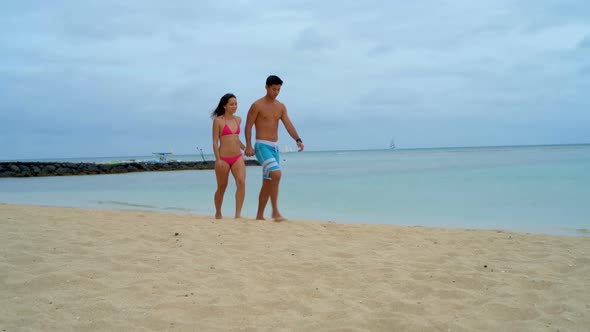Couple walking on the beach 4k