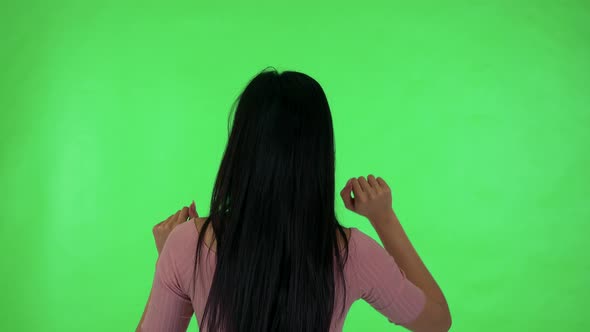 Young Attractive Asian Woman Works on Background As on Tablet or Smartphone - Green Screen Studio