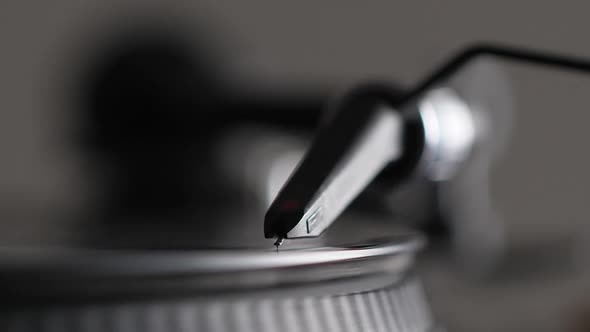 Male Hand Put Needle on Record Spinning on Turntable