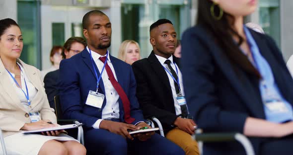 Business people raising their hands in a business seminar 4k