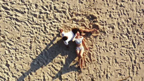 Young people married on vacation live the dream on beach on white sand background 4K