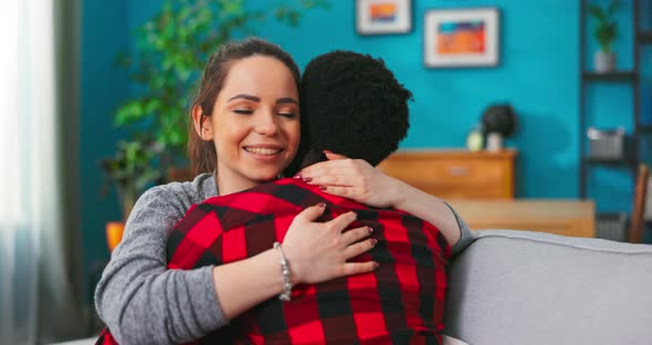 Close Up of Happy Lovely Beloved Coupe Young Man and Beautiful Woman Hugging Together Sitting