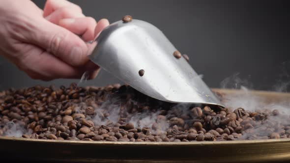 Man Hand Holding Ladle Scooping Coffee Seeds Close Up