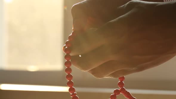 Hands and Beads at Sunset