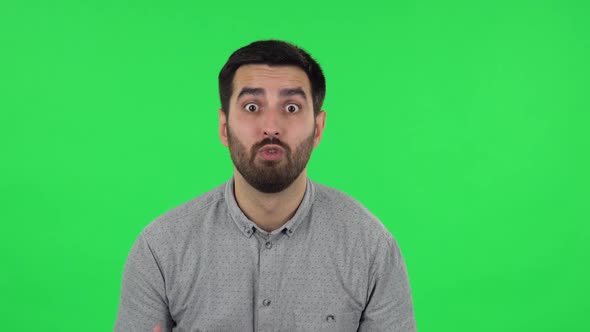 Portrait of Brunette Guy Is Looking at Camera with Anticipation, Then Very Upset. Green Screen
