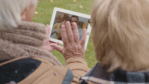 Elderly Man and Woman Having Video Talk Using Tablet