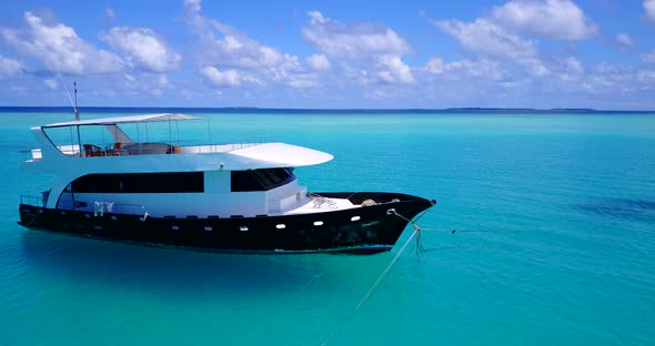 Luxury overhead island view of a white sand paradise beach and aqua blue water background in colorfu