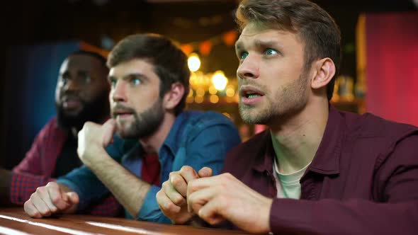 Multiracial Fans Celebrating Favorite Team Scoring Goal, Watching Game in Pub