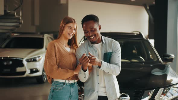 Close Up of Happy Multicultural Couple Posing at Modern Dealership Center with