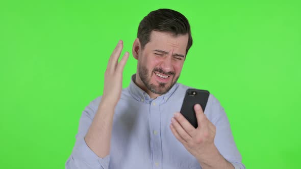 Portrait of Man Reacting to Loss on Smartphone Green Screen