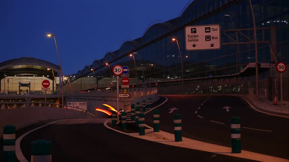 Nighttime at an international airport terminal with signs in Spanish - long exposure time lapse with