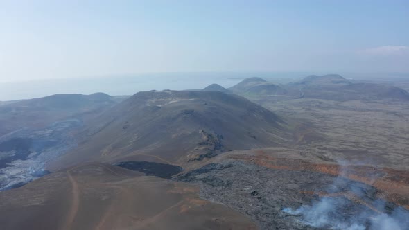 Aerial Drone View of Icelandic Mountains Surrounded By Black Lava Fagradalsfjall Fissure Eruption