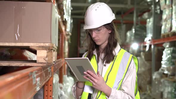 The Girl Warehouse Manager Keeps a Tally on a Clipboard