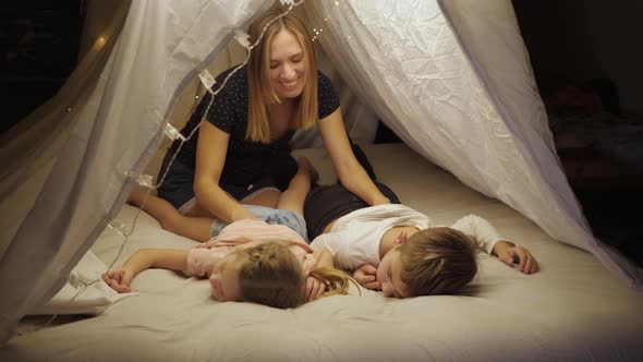 Happy Mom Massages the Children