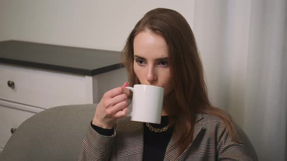 Portrait of Satisfied Businesswoman Drinking Tea at Home Office