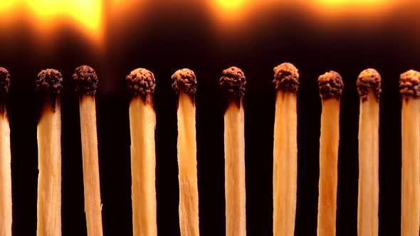 Burning matches on a black background.