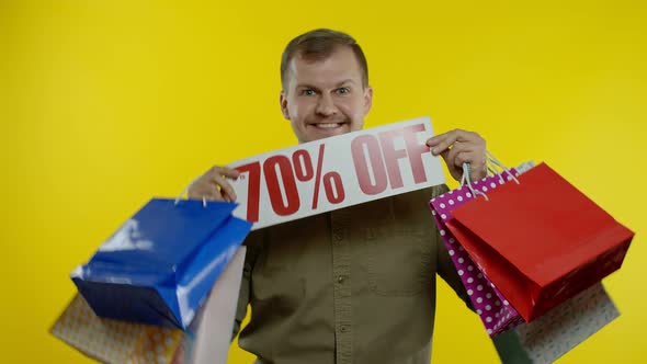 Happy Man Dancing, Celebrating, Showing Shopping Bags and Up To 70 Percent Off Inscription