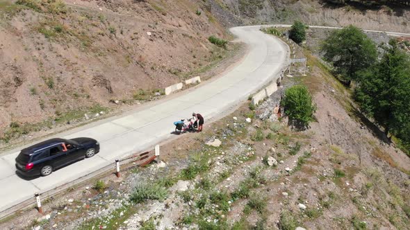 Cyclist On The Road Shoulder Packing