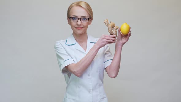 Nutritionist Doctor Healthy Lifestyle Concept - Holding Ginger Root and Lemon Fruit