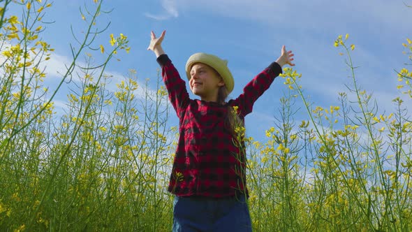 Happy Little Girl with Hat with Her Hands Up