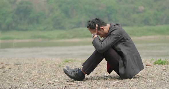 Young Asian Businessman Sitting And Depressed