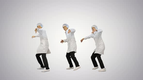 Three Male Doctors in White Robes and Protective Caps Doing Synch Dance Routine Looking at Camera on