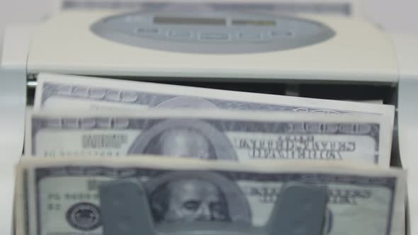 Hundred Dollars Banknotes are Counted in the Machine for Account Banknotes Closeup