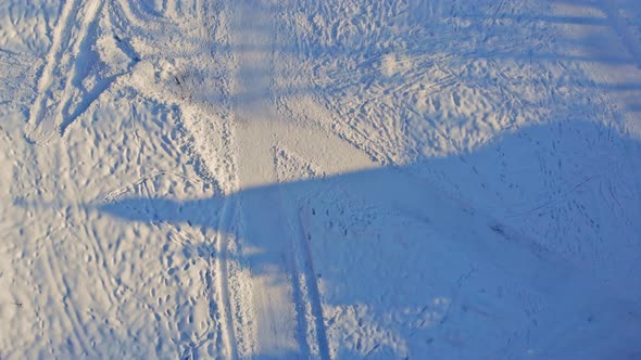 Aerial view on of trail, snowy forest path a after snowfall severe winter weather