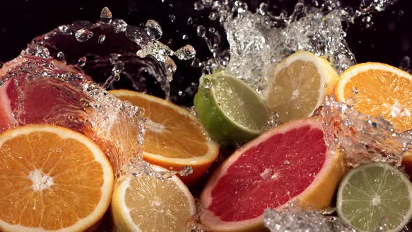 Slow Motion Shot of Citrus Fruits and Water Splashing Through Lemon Lime Grapefruit Slices