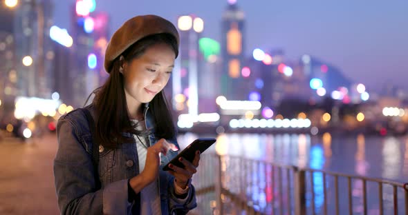 Young woman use of mobile phone at night