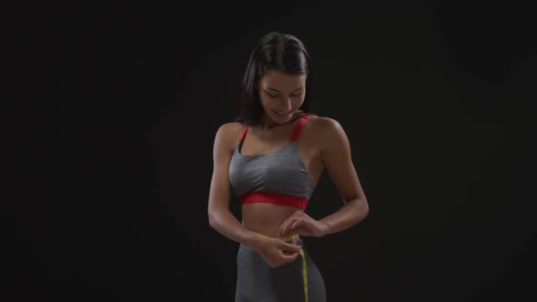 Woman measuring her waist