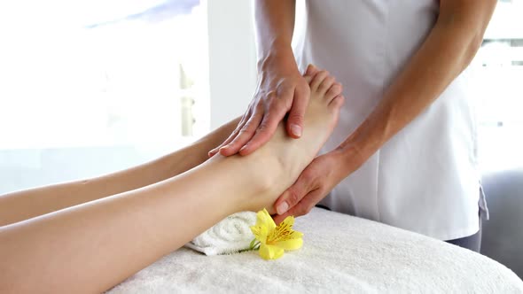 Close up of woman therapist massaging the feet of her patient