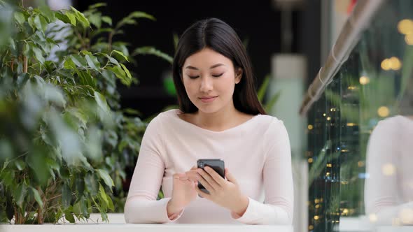 Asian Korean Woman User Blogger Female Vlogger Chinese Japanese Lady Sitting at Cafe Table Looking