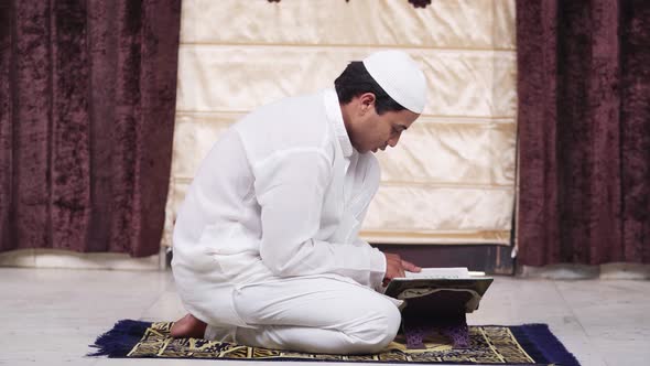 Muslim man reading Quran