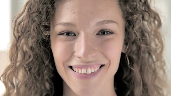 Face Close Up of Smiling Curly Hair Woman