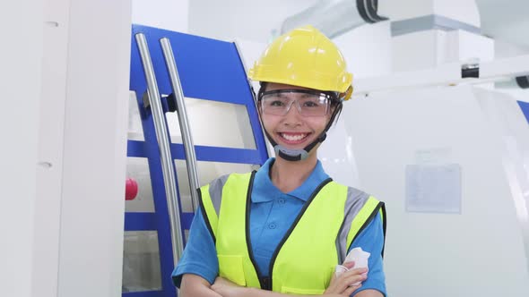 Asian woman worker people removing protective face mask in production factory due to covid 19.