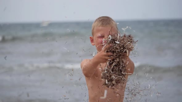 Beach Summer Vacation. Children's Emotions. The Child Develops Tinsel in the Wind