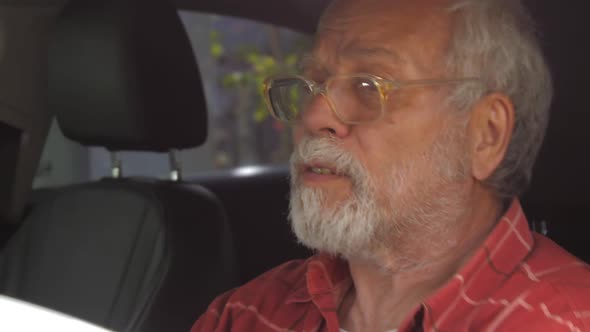 Senior Driver Man Stands in Traffic Jam Near Ambulance alt