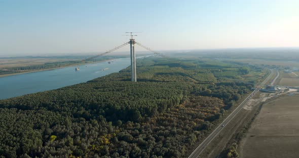 Concrete Column And Cranes Surrounded By Danube Riverbank