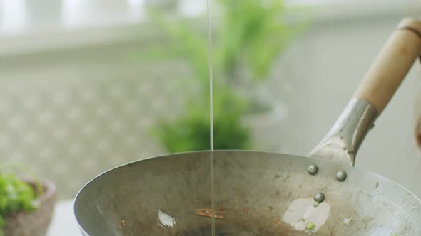 Anonymous person frying eggs in pan