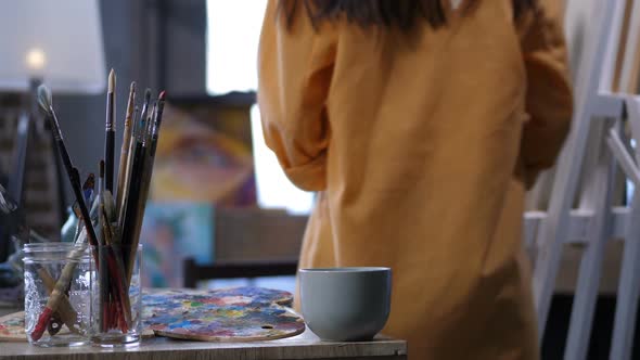 Female Painter Creating Work of Art in Workshop