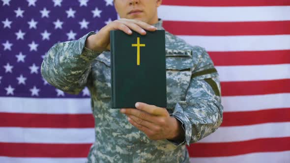 Military Peacekeeper Showing Bible, American Flag Background, Faith Symbol Hope