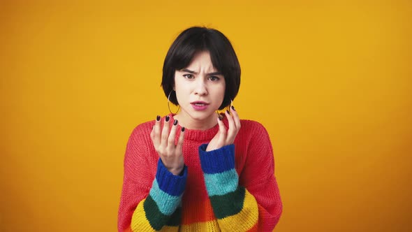 Young Displeased Woman Looking at Camera Annoyed with Her Skin Condition Orange Studio Background