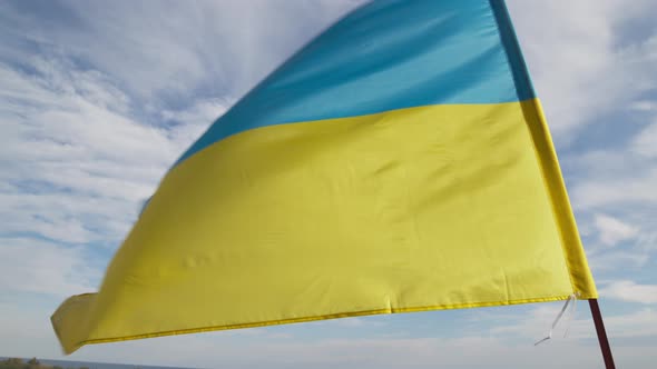 Ukrainian Flag Waving in the Blue Sky