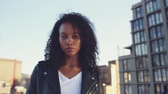 Fashionable young woman on urban rooftop