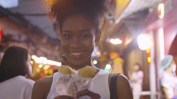 An Attractive girl is enjoying a night out on Yaowarat Road or Chinatown in Bangkok, Thailand.