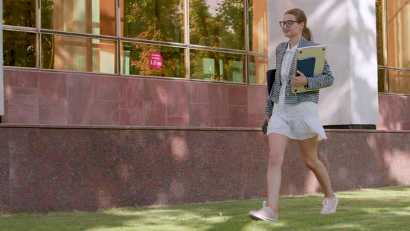 the Young Student Dressed in a Dress Goes Happily to the University