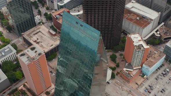 Sky Reflecting in Tilted Glass Facade of Tall Building