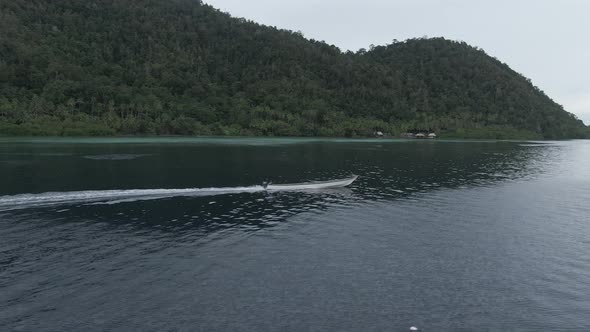 Aerial View Of Boat Splashing Water In Triton Bay In Kaimana Islands.