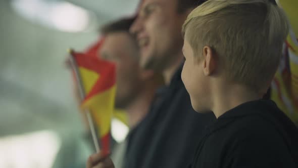 Child and Adult Spanish Football Fans Waving Flag, Singing National Anthem